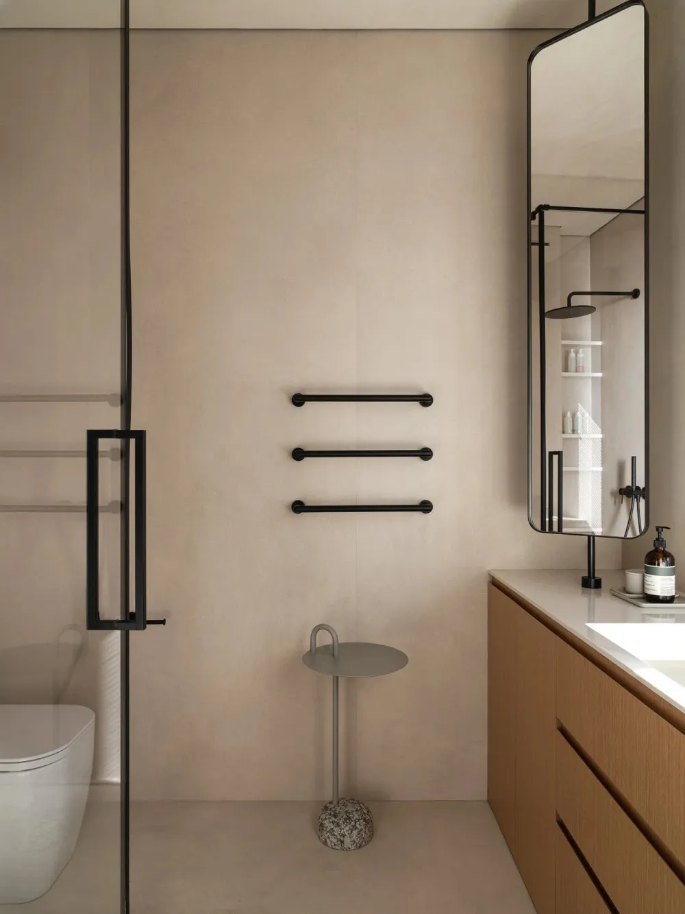 Modern minimalist bathroom featuring glass shower enclosure, minimalist vanity, wooden cabinetry, and concrete floor.
