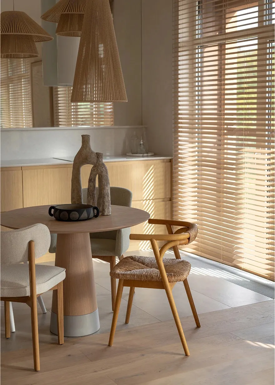 Modern kitchen with woven chairs and wooden furniture