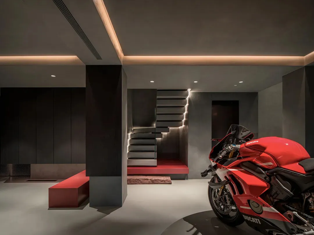 Contemporary motorcycle showroom with minimalist design, featuring a sleek Ducati motorcycle on display.