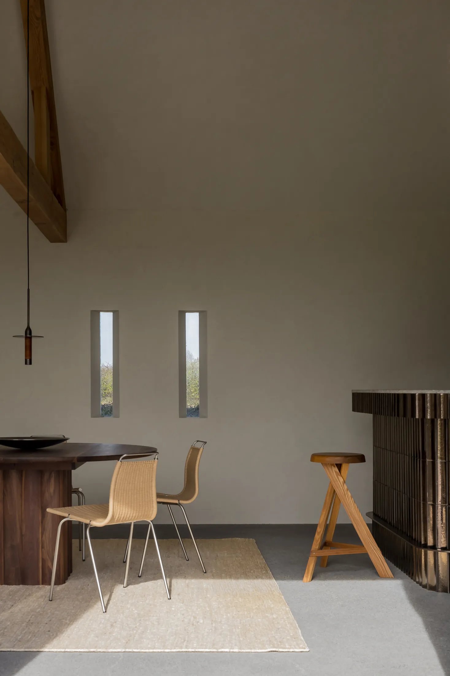 Industrial-style dining room featuring wooden furniture and a minimalist design.