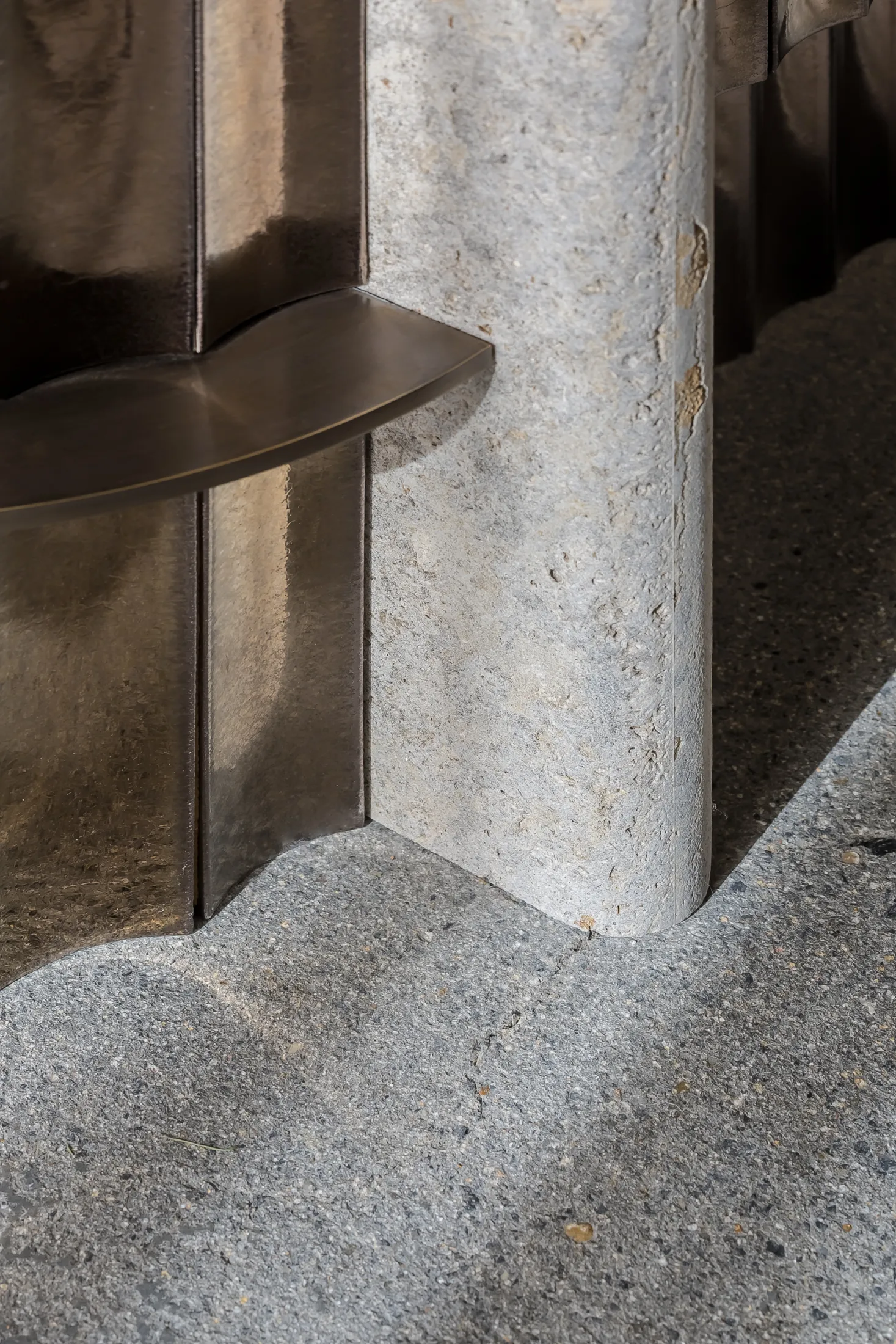 Metal column with a stone foundation in an architectural setting