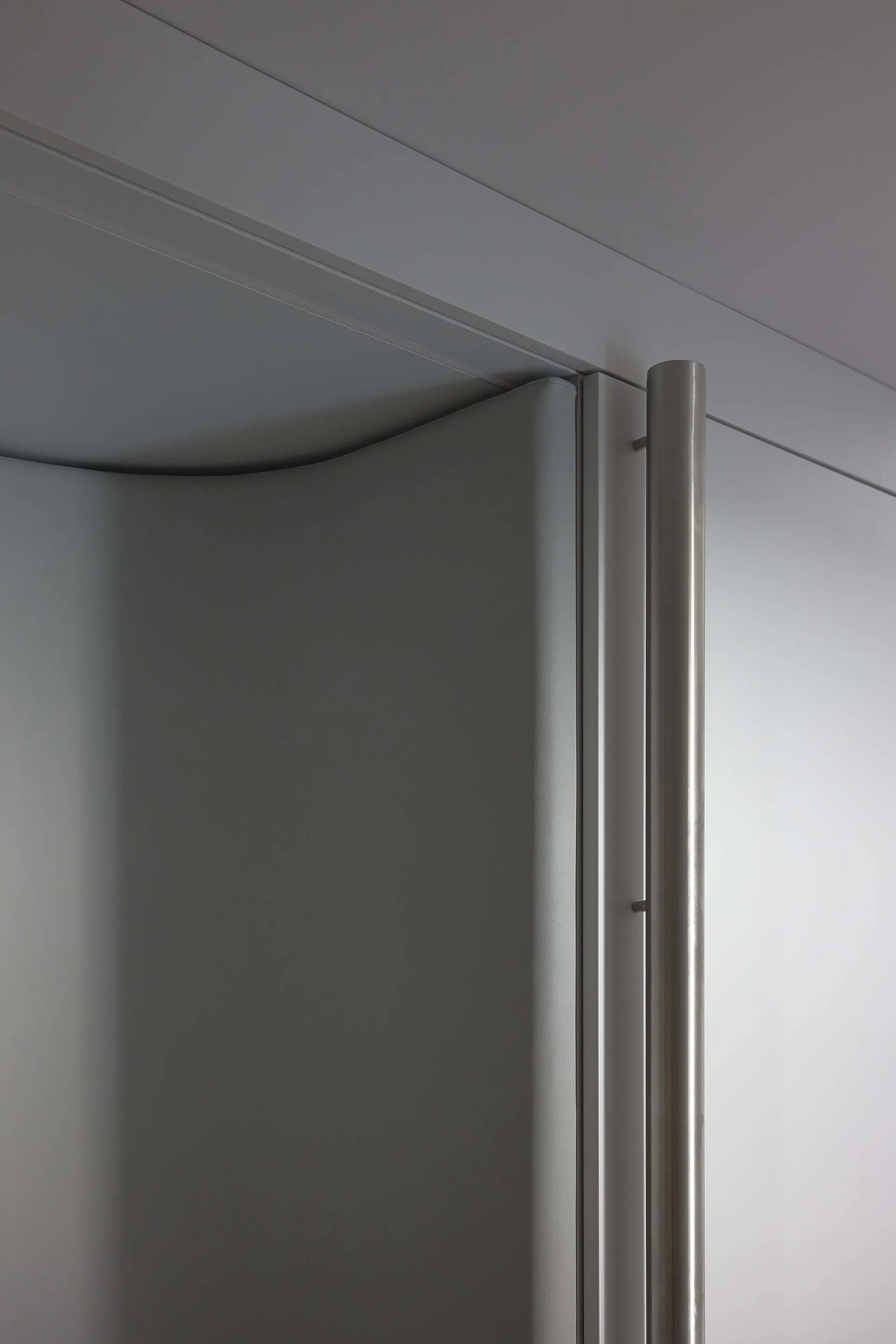 Modern industrial-style closet with metallic grey paneling and sleek, minimalist design.