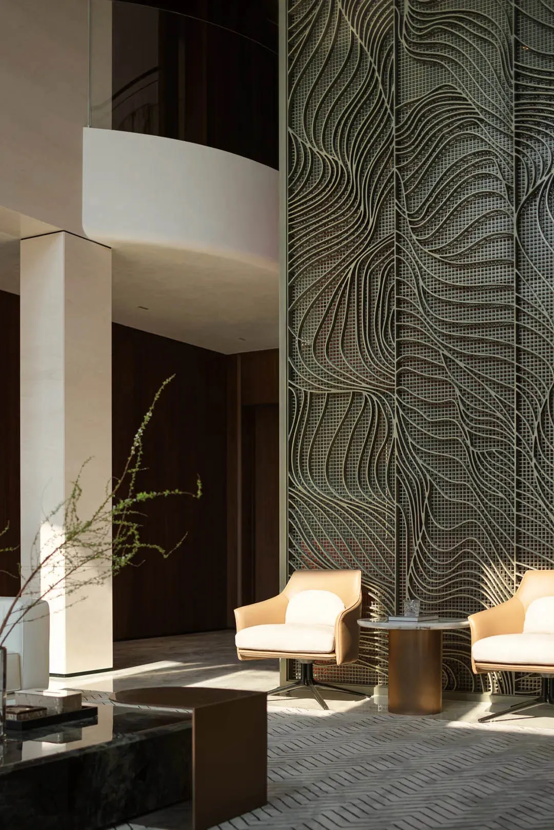 Modern industrial lobby featuring metallic patterns, concrete walls, and contemporary furniture.