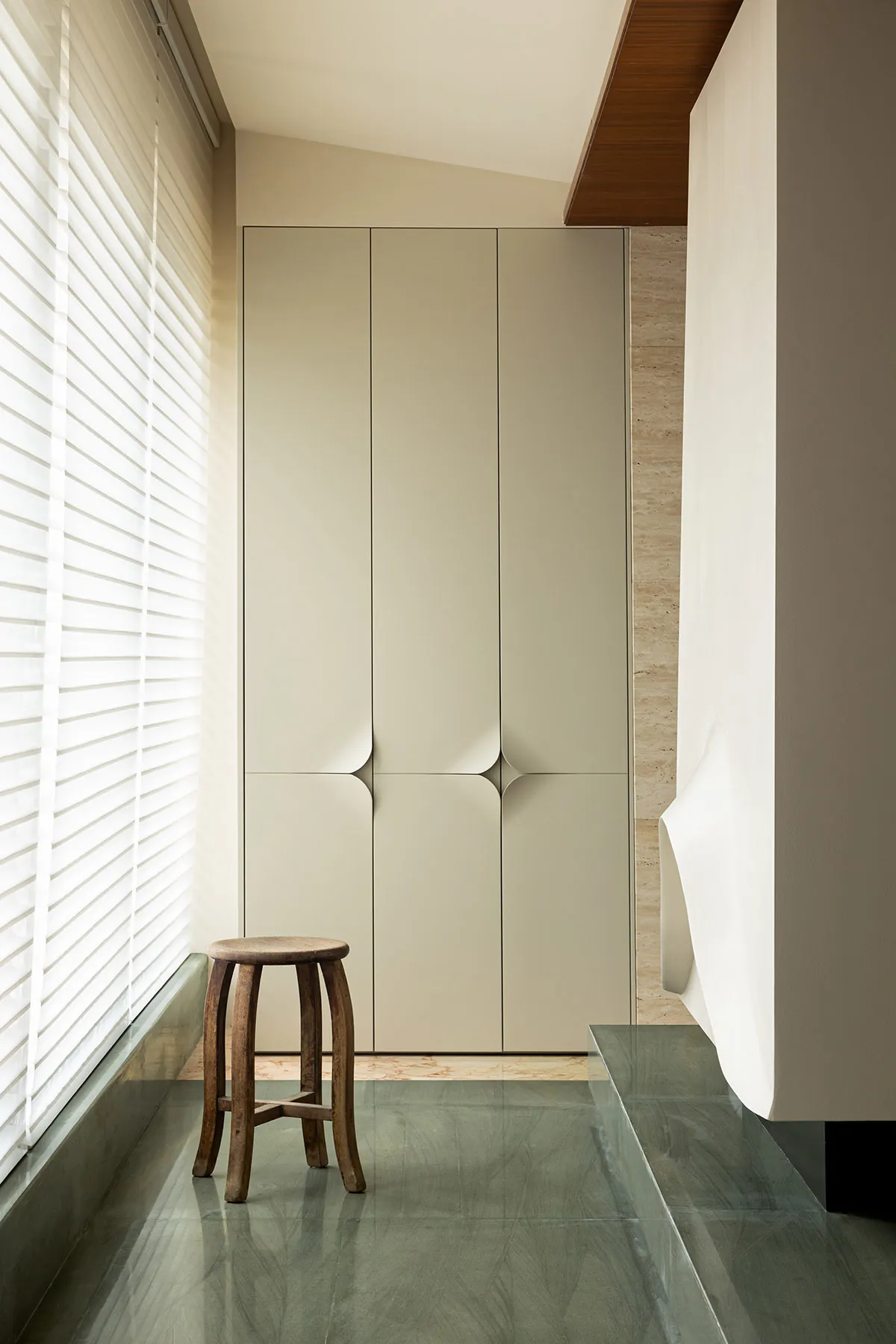 A modern flat-panel wardrobe with white doors and a minimalist design.
