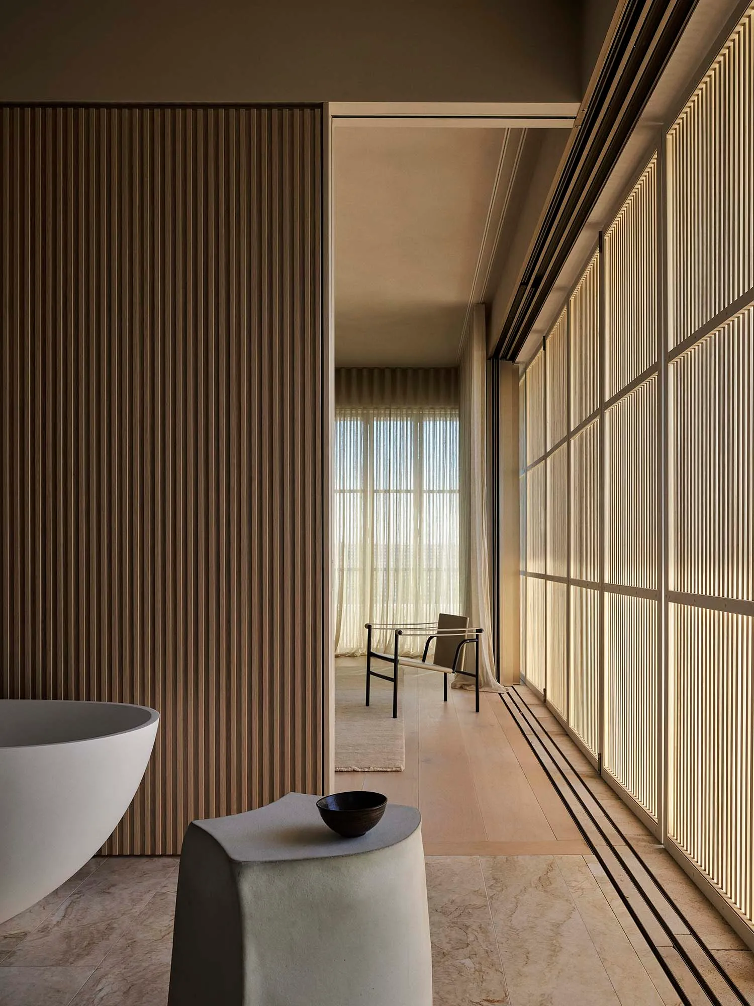 Modern minimalist bathroom designed with white marble materials.