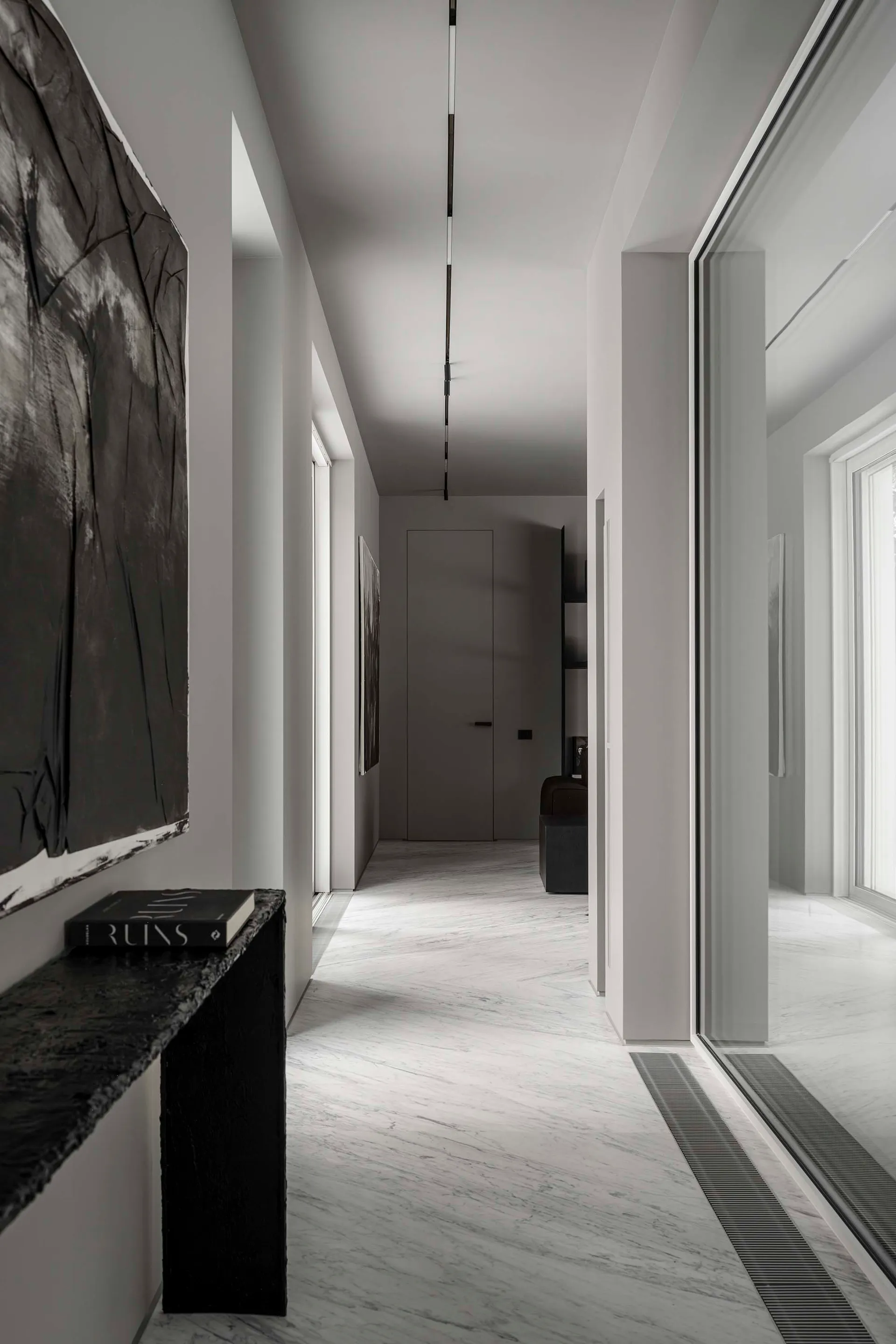 Modern white marble interior with minimalist design and black accents.