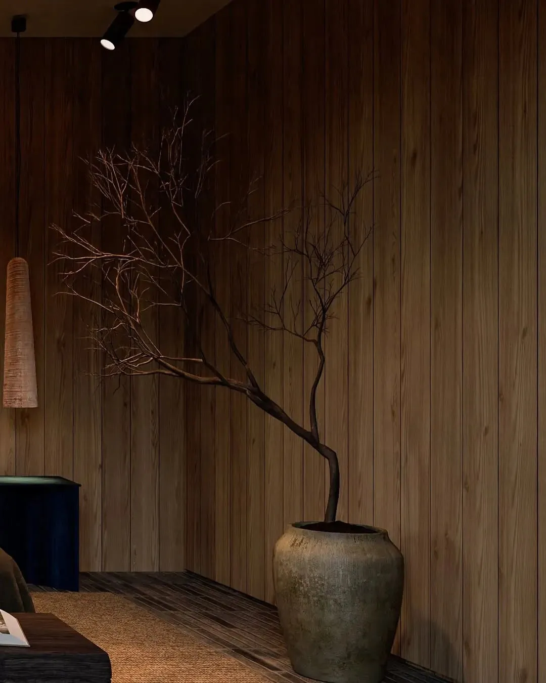 Modern minimalist bedroom with a wooden accent wall and a single branch plant in a vase.