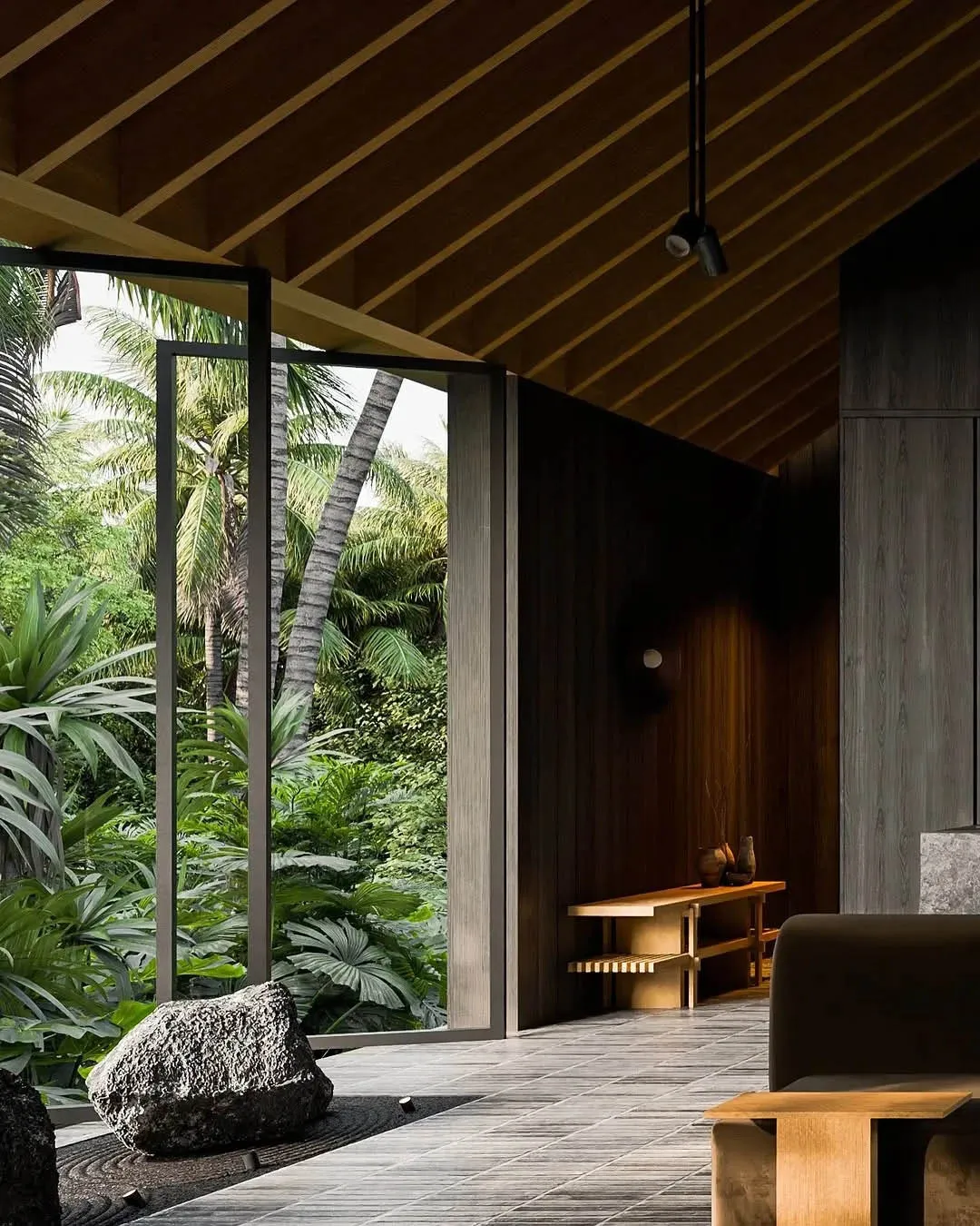 A minimalist living room interior with wooden elements and a view of a tropical outdoor space.
