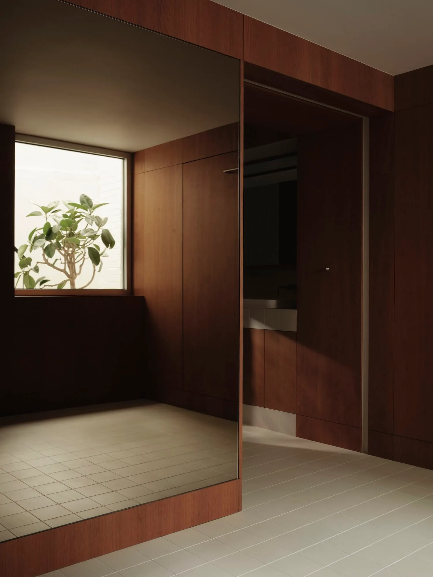 Modern bathroom featuring wood paneling on walls, white tiled floor, and a window with a plant.
