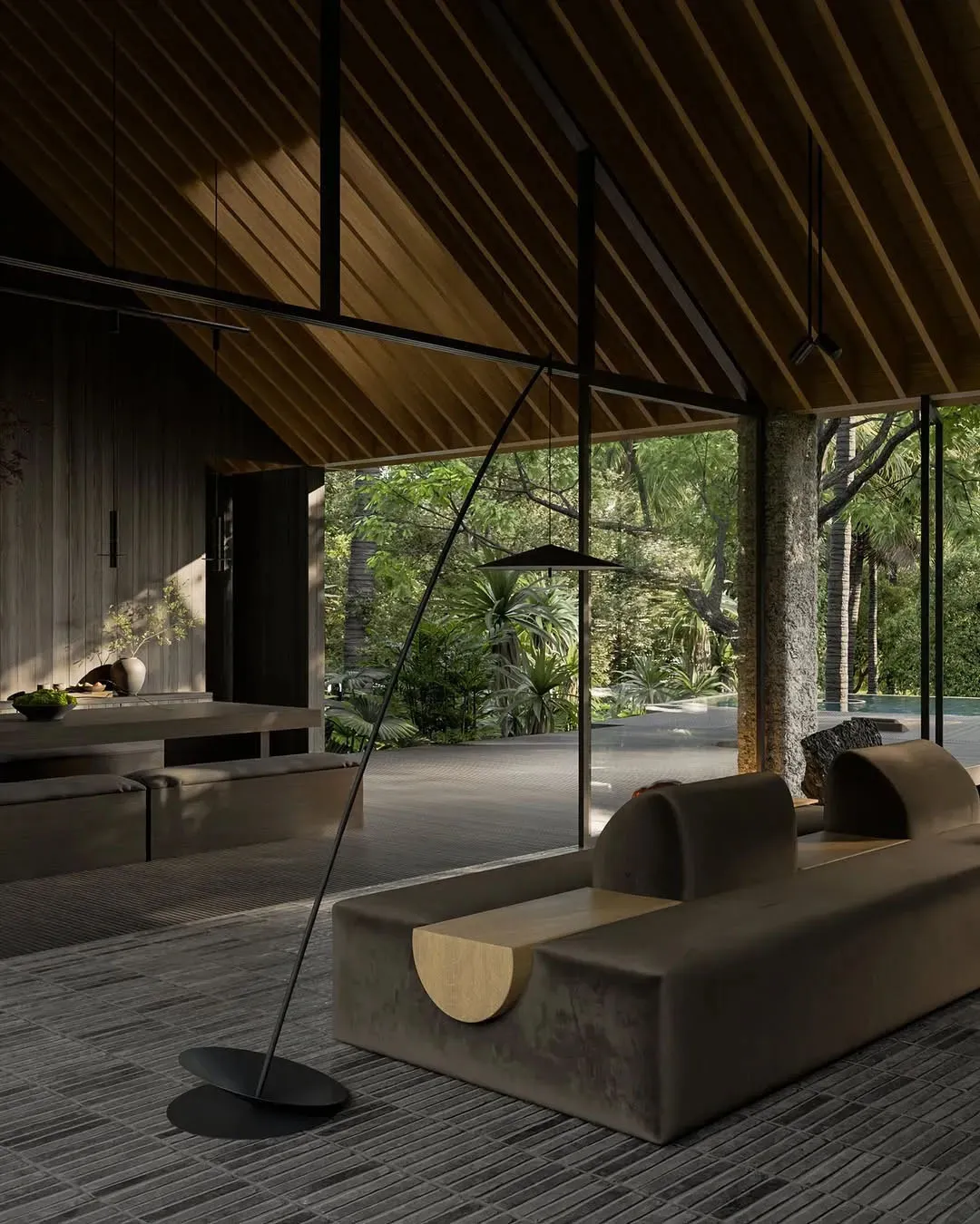 Contemporary-style living room with a modern sofa upholstered in dark wood material and large windows overlooking natural sur