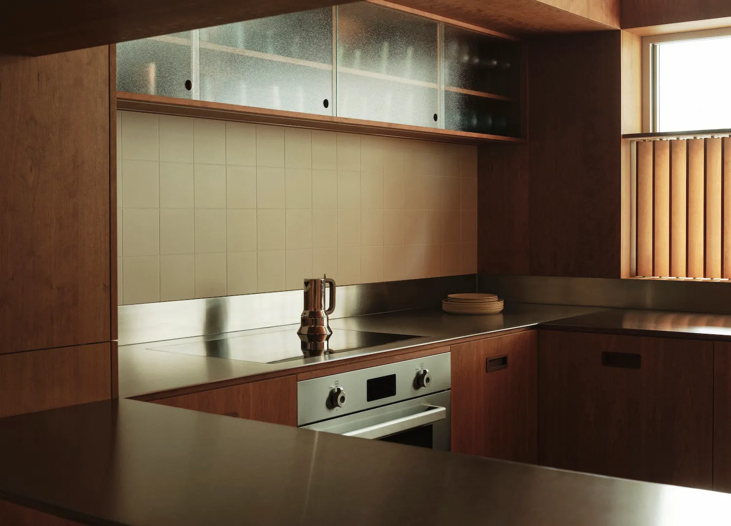 A modern kitchen with wooden countertops and tiled backsplash.