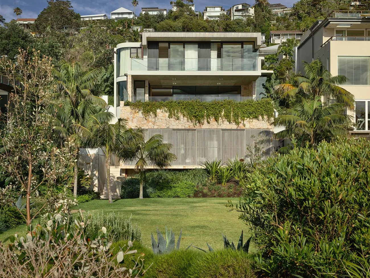 Modern house with stone exterior and green landscape