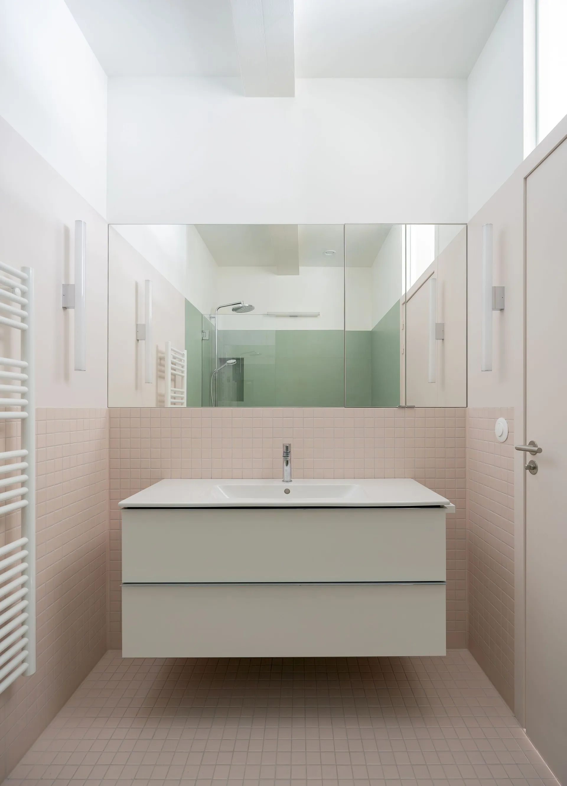 Modern minimalist bathroom with ceramic tile walls and metallic accents.