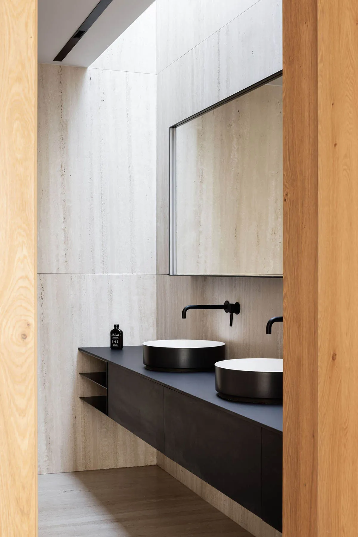 Modern bathroom featuring concrete walls and minimalist design elements.