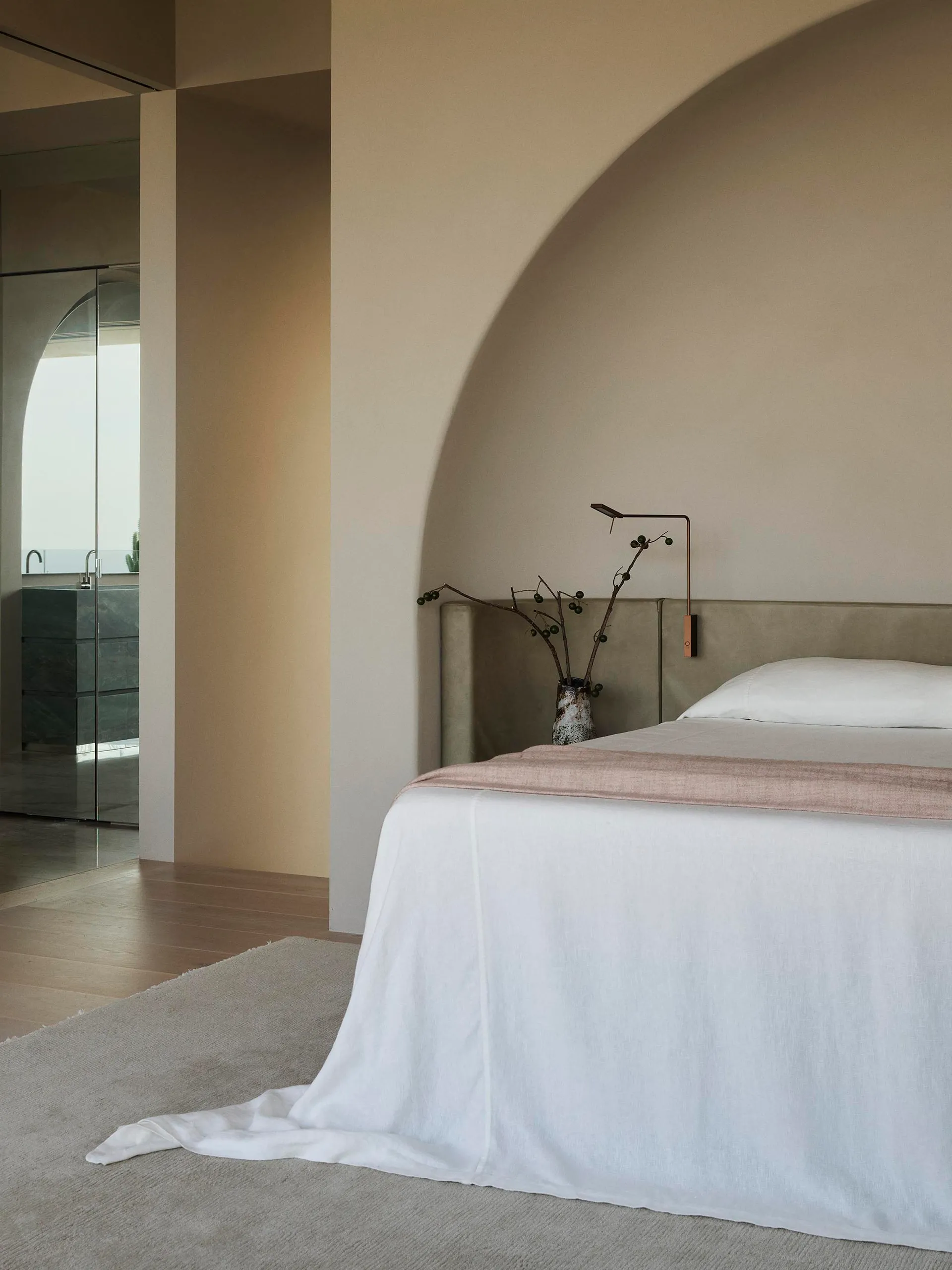 A modern bathroom with concrete tiles, featuring a walk-in shower and white accents.
