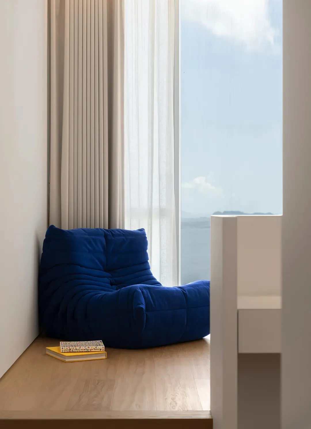A modern residential space featuring wood and fabric elements.