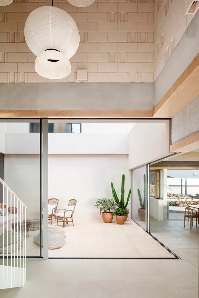 A minimalist living space featuring concrete flooring and a modern design.