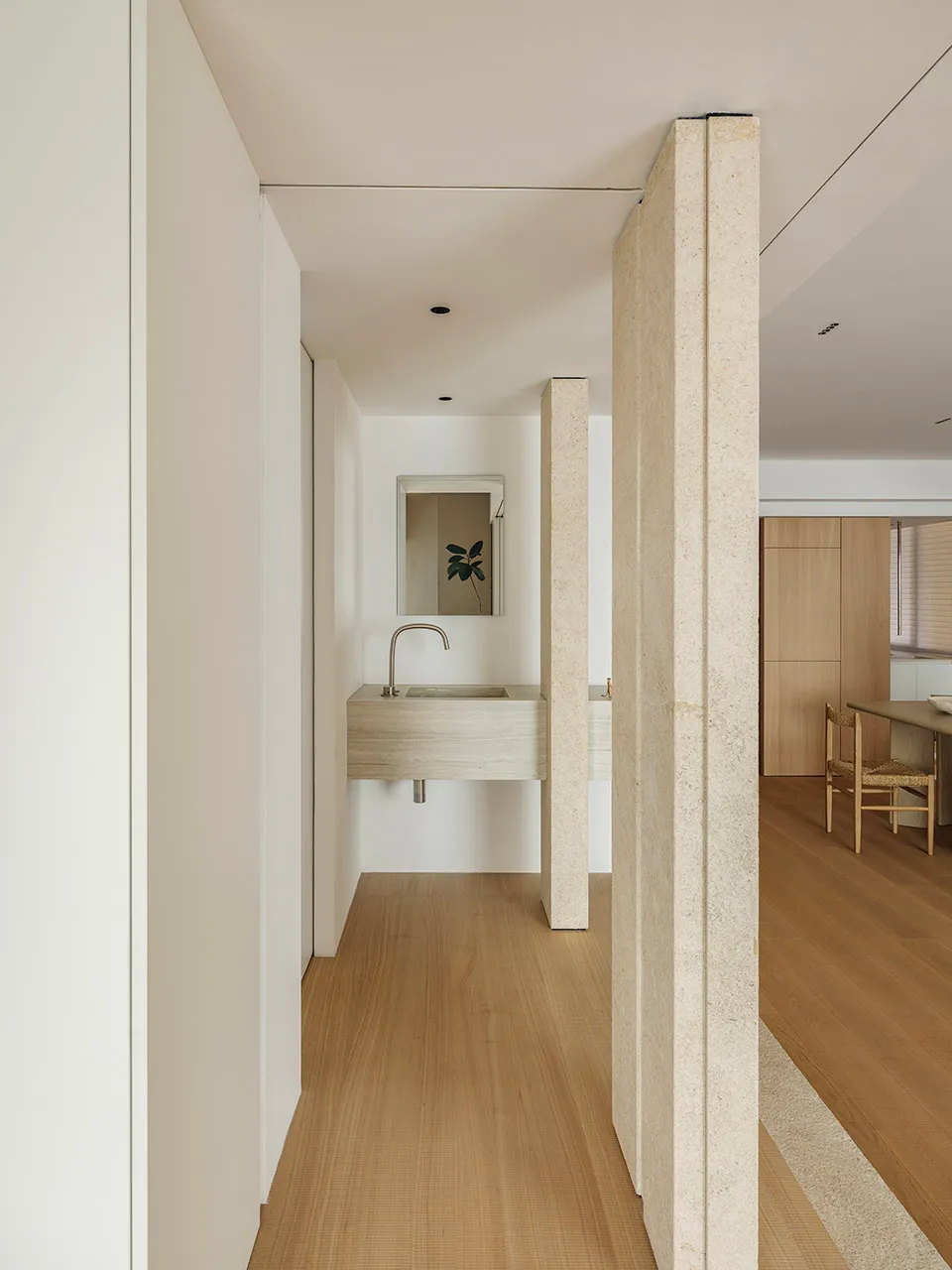 Modern minimalist bathroom featuring marble finishes and a minimalist design.