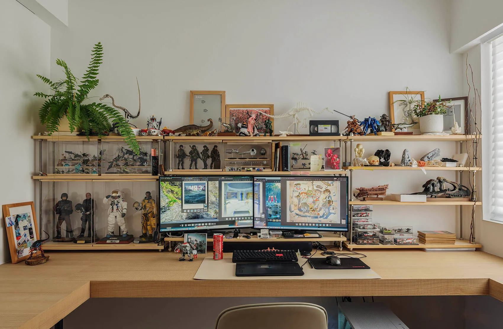 A well-organized workspace featuring a variety of sculptures and decorative items arranged on a wooden desk.