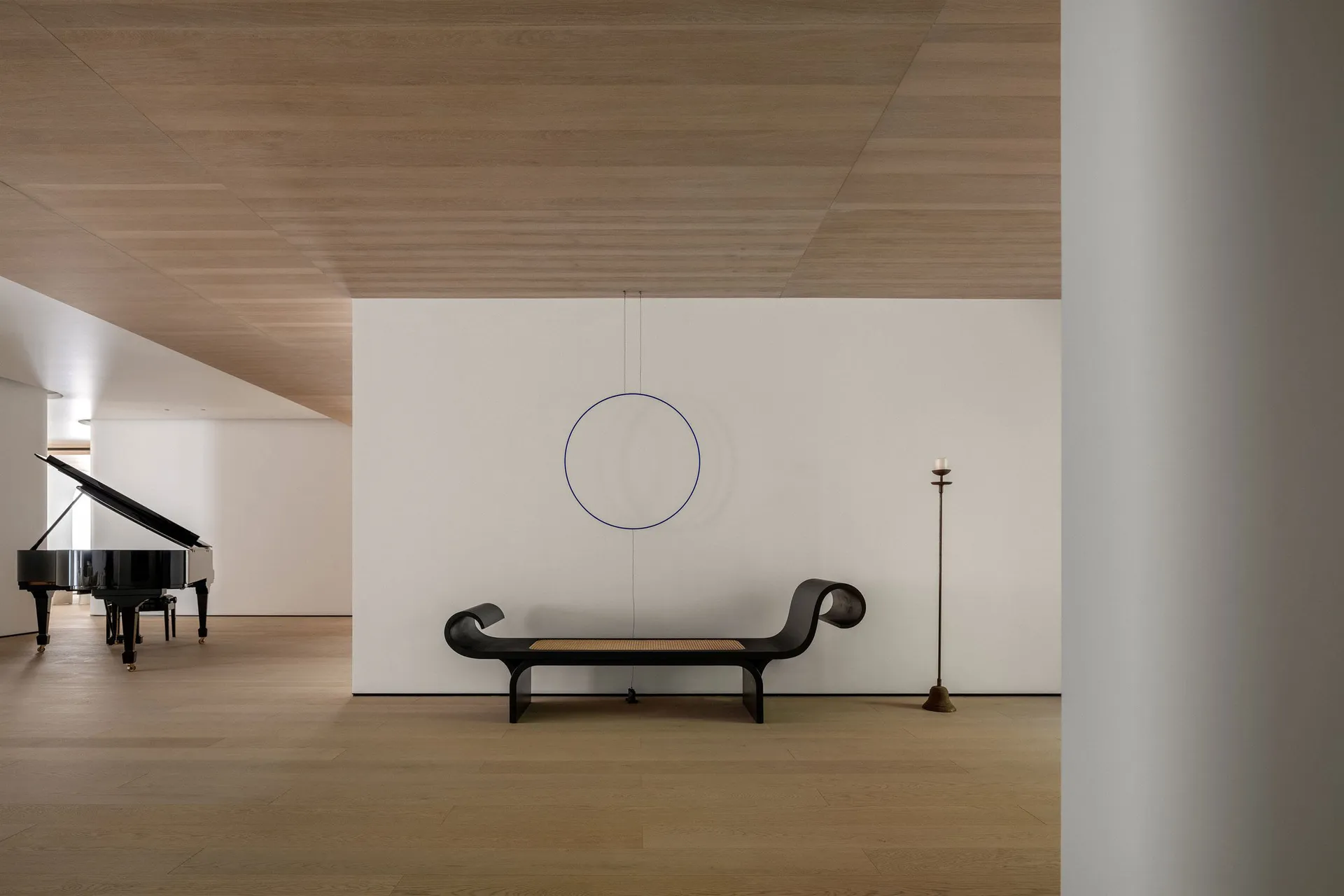 Minimalist style interior space featuring a combination of wood and metal materials and furniture.