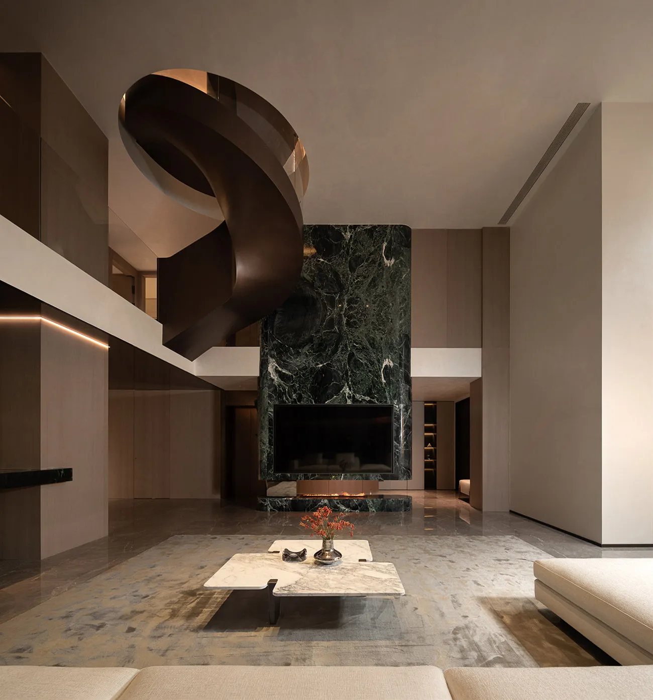 A modern living room featuring a marble fireplace and spiral staircase.