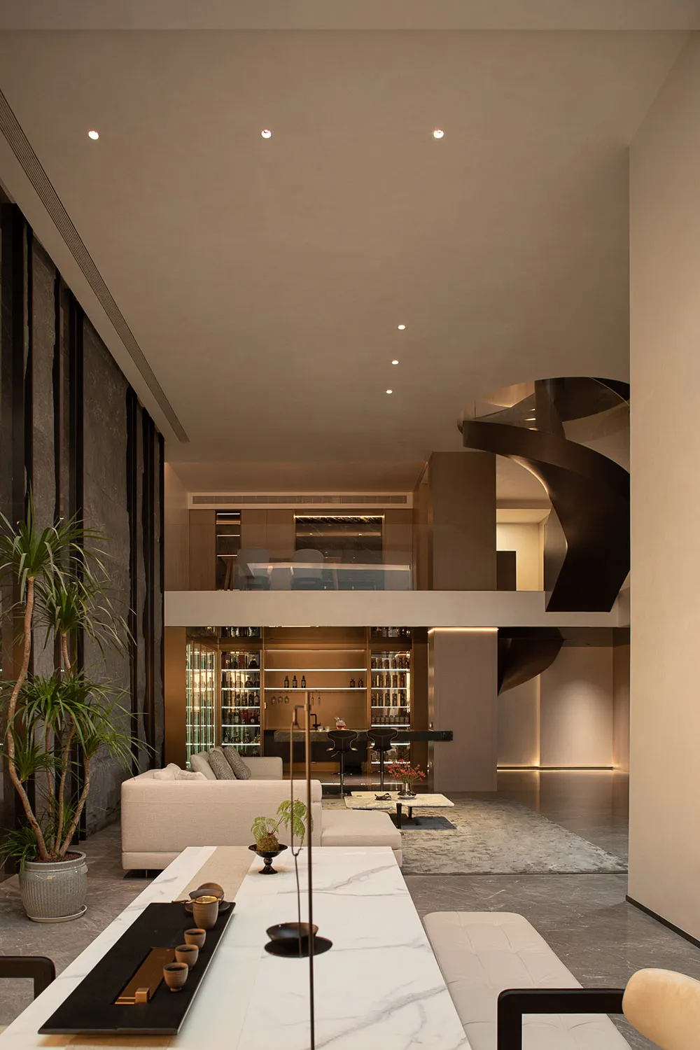 Modern minimalist living room featuring a bar area with marble and concrete elements