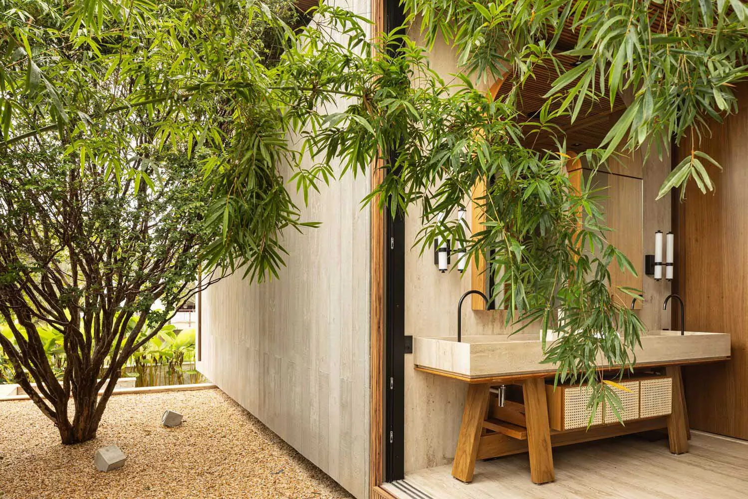 A modern bathroom featuring concrete walls and a wooden sink with a natural stone countertop.