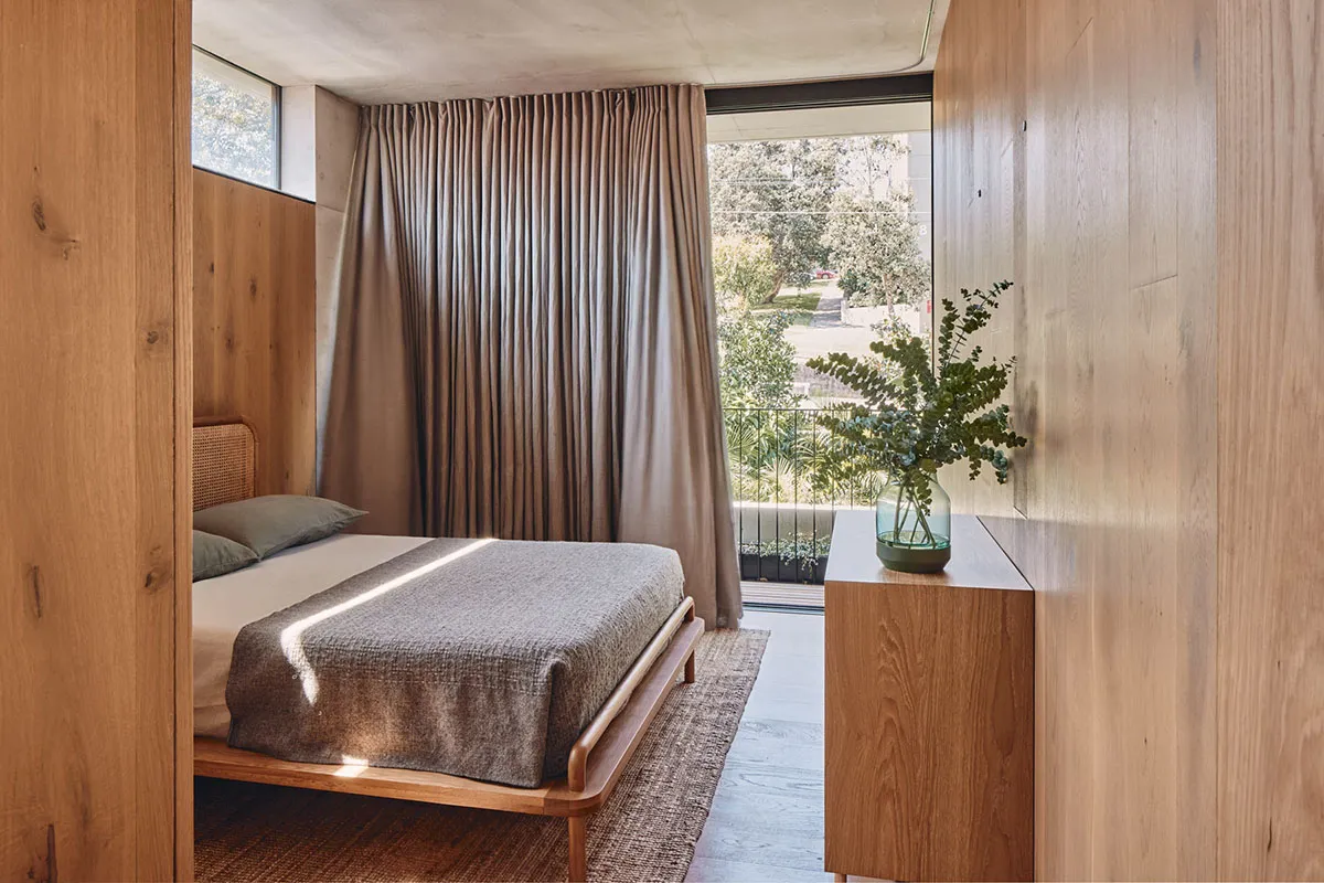 A modern bedroom featuring wooden furniture and a cozy atmosphere.