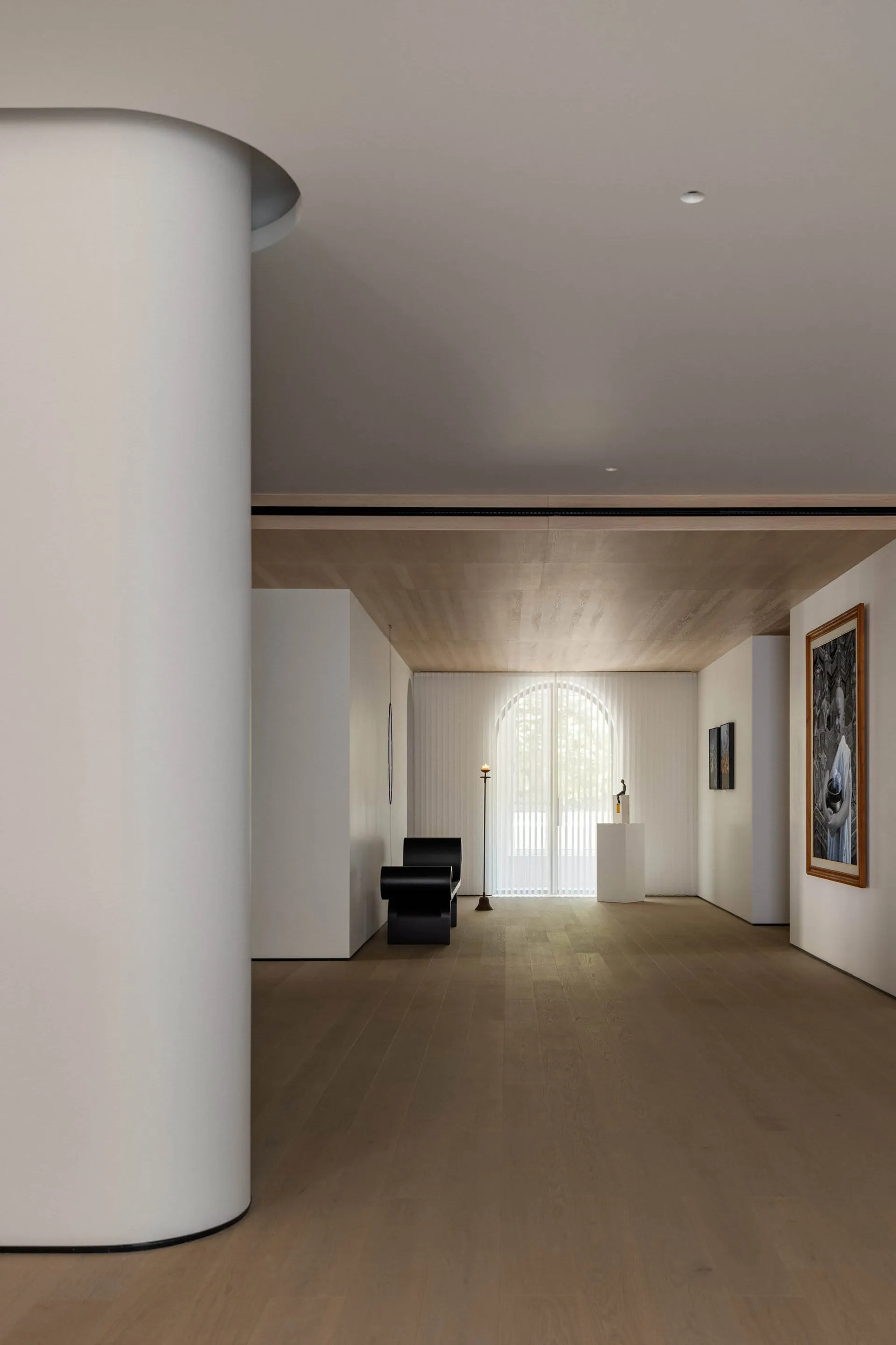 A modern interior with white marble walls and floor, featuring minimalist decor and a sleek, contemporary design.