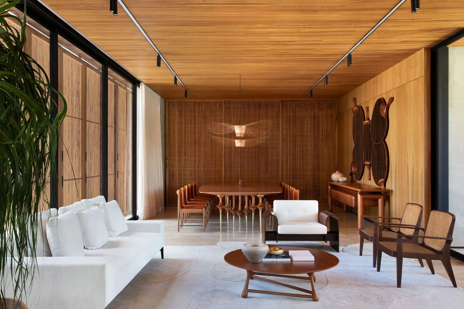 A modern living room with wooden furniture, a white sofa, and a wooden table.