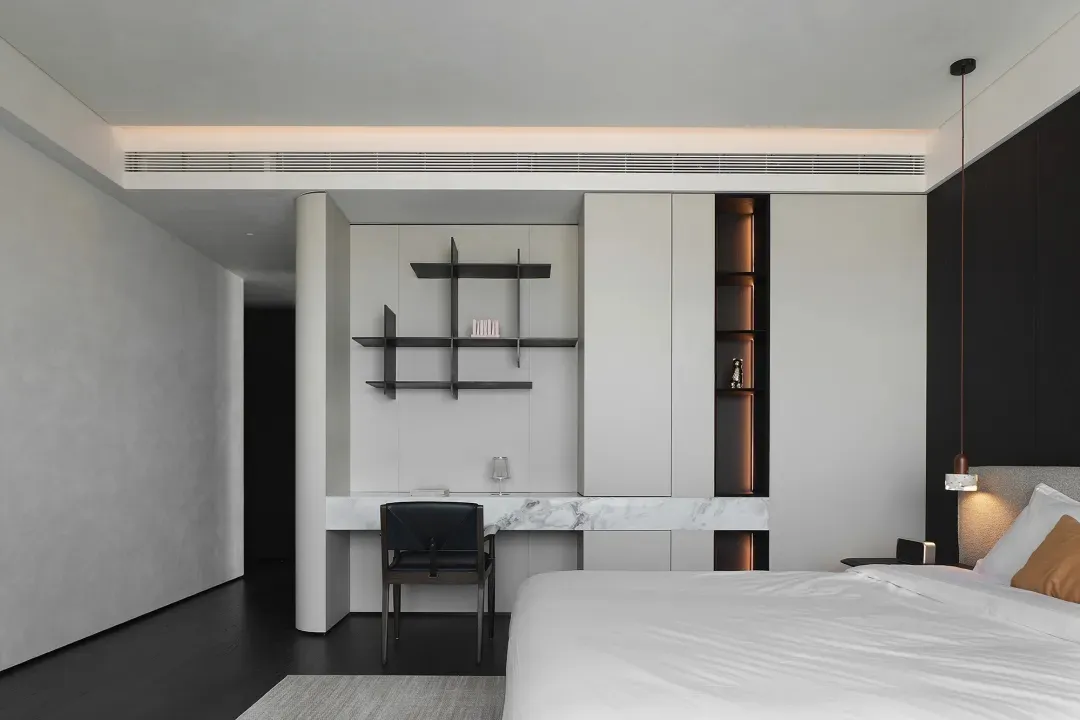 Modern bedroom featuring white marble floors and walls, minimalist design, and white bedding.