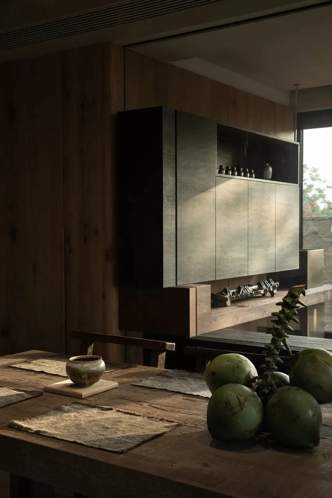 A modern kitchen with wooden cabinets and a wooden dining table.