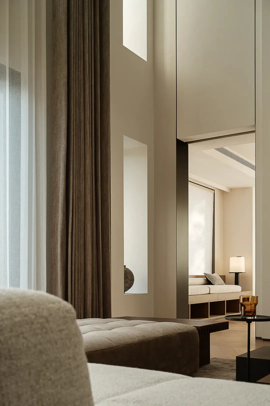 Modern minimalist living room with fabric seating and wooden accents.