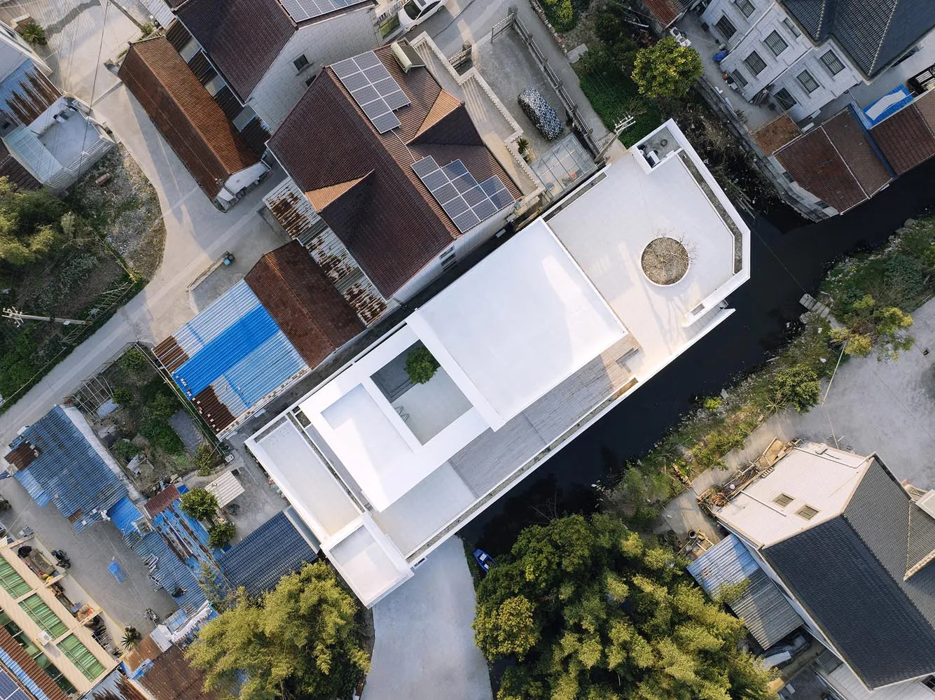 An aerial view of a modern residential floor plan featuring a white roof.