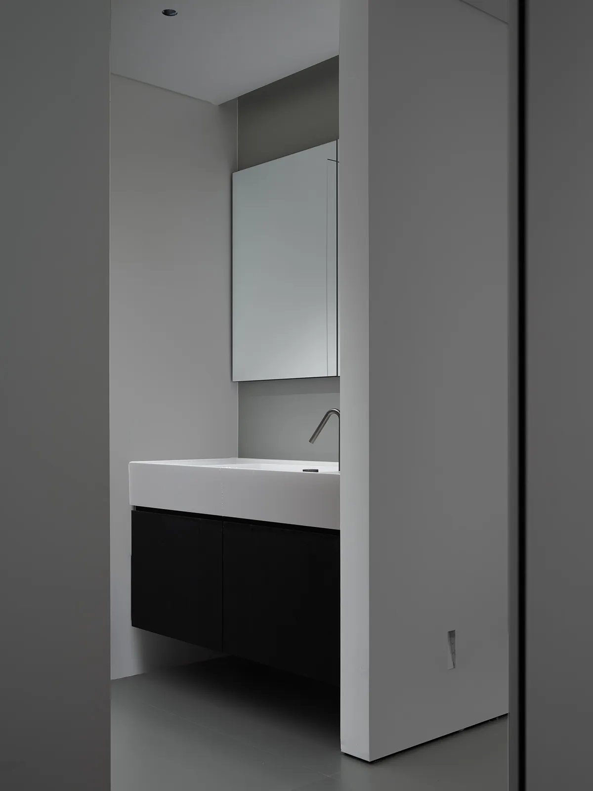 Compact modern bathroom with a ceramic sink, minimalistic design, and sleek, clean lines.