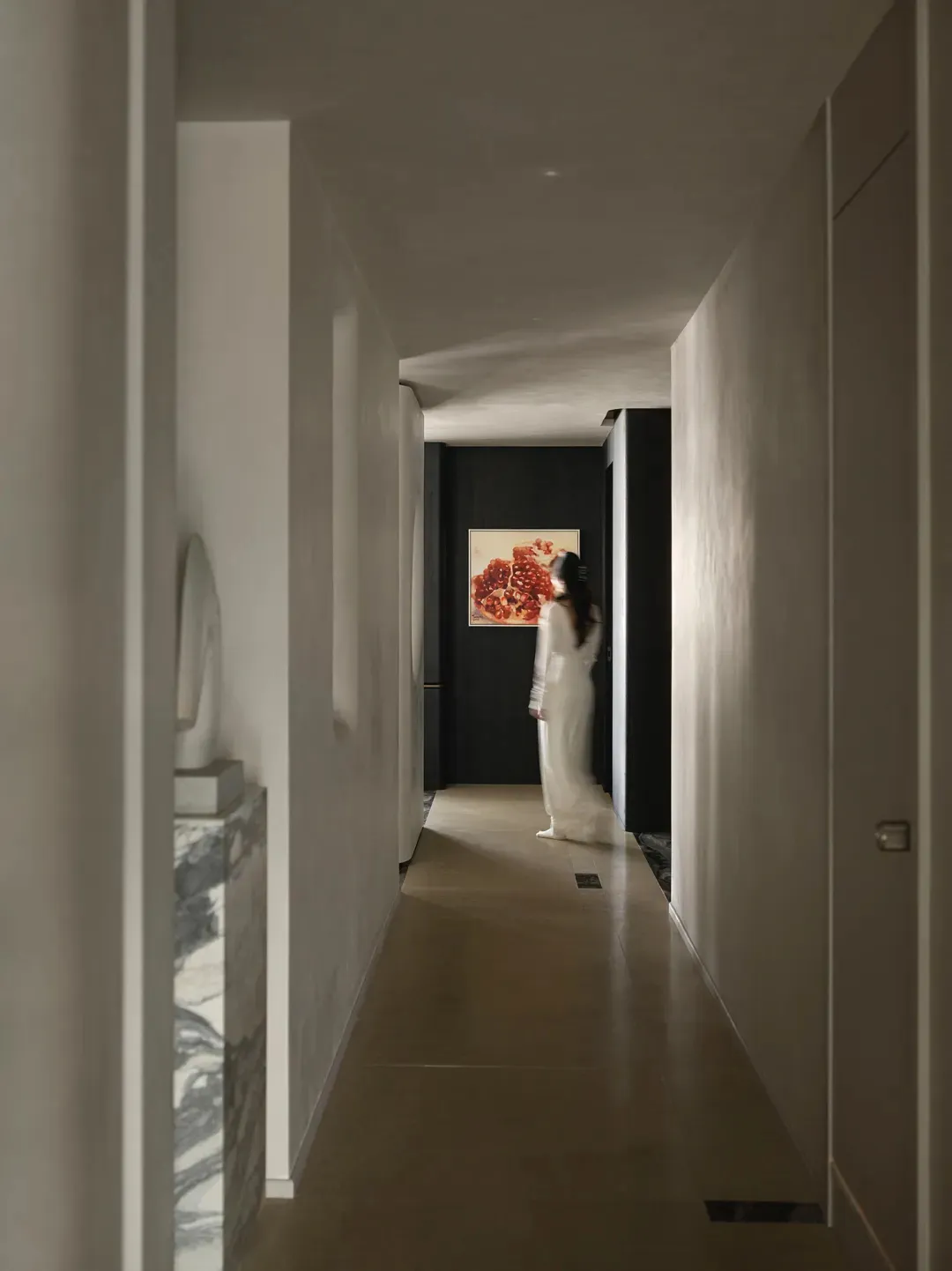 A modern interior corridor with white mineral walls, featuring a minimalist design.
