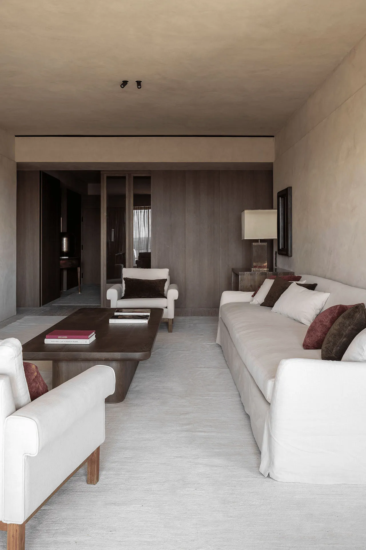 A minimalist living room with neutral-toned furniture and minimalist decor.