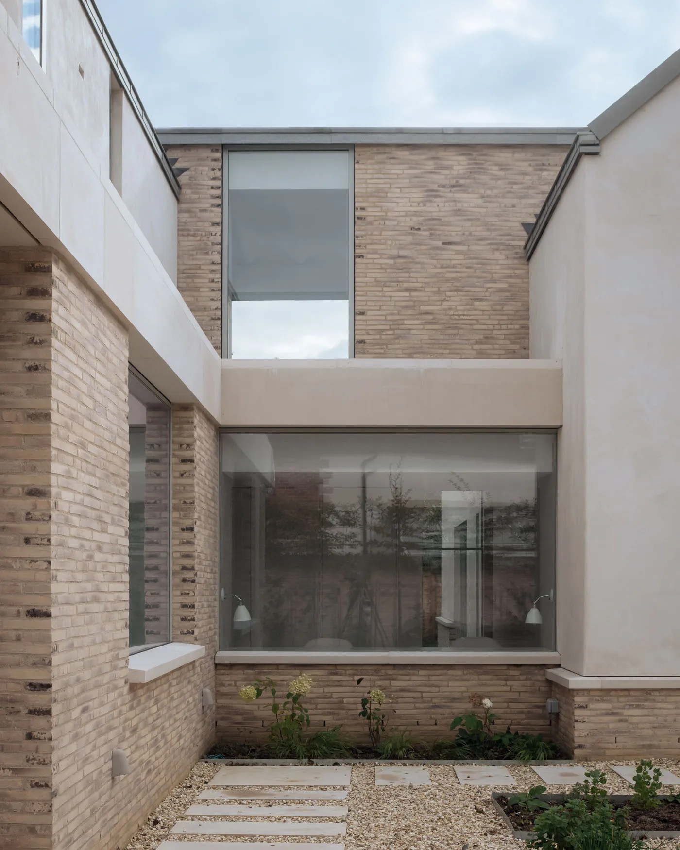 Modern house with brick exterior and large windows.