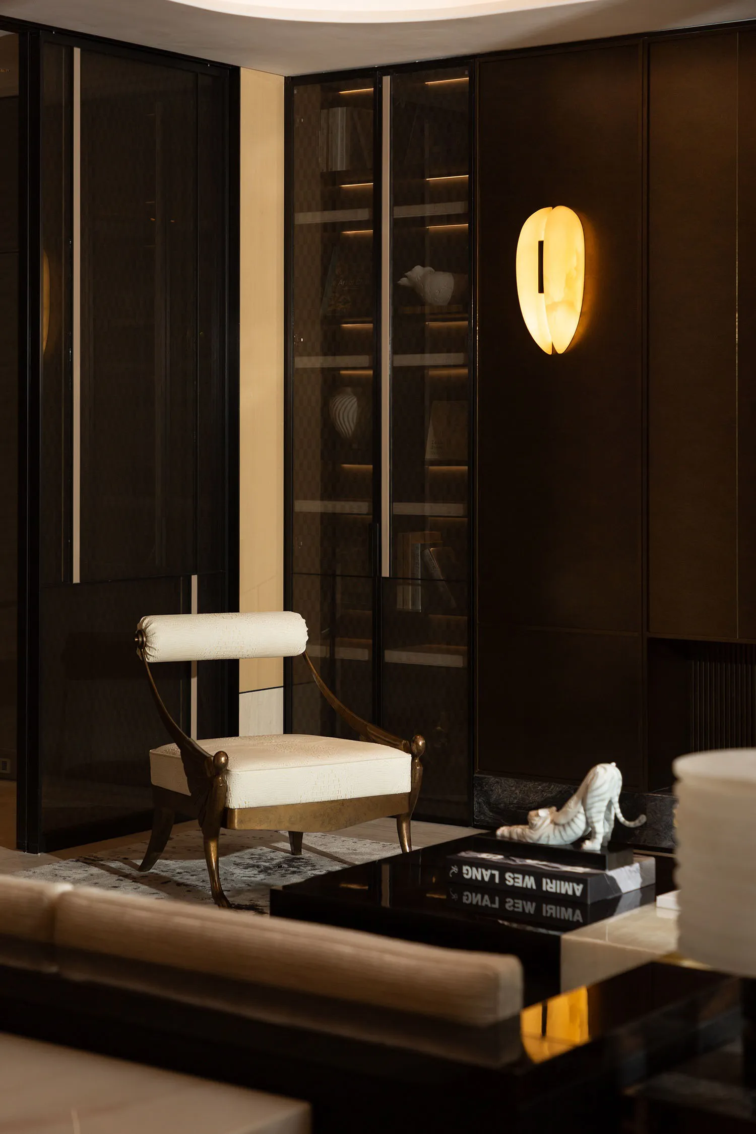 Modern living room featuring glass walls, leather seating, and marble accents