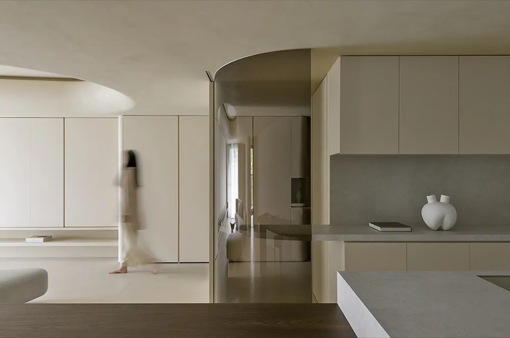 A modern, minimalist kitchen features concrete countertops and wooden cabinets, with a sleek, clean design.