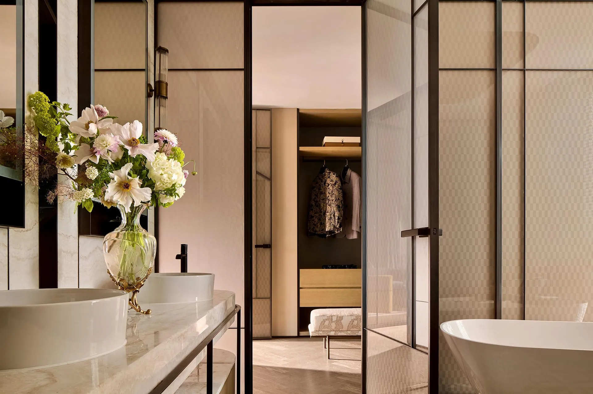 Modern bathroom design featuring a walk-in closet with open concept layout and stone finishes.