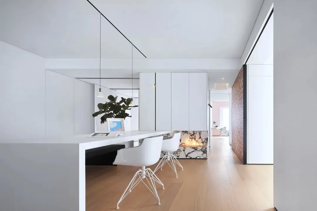Modern living room featuring marble elements and white furniture.