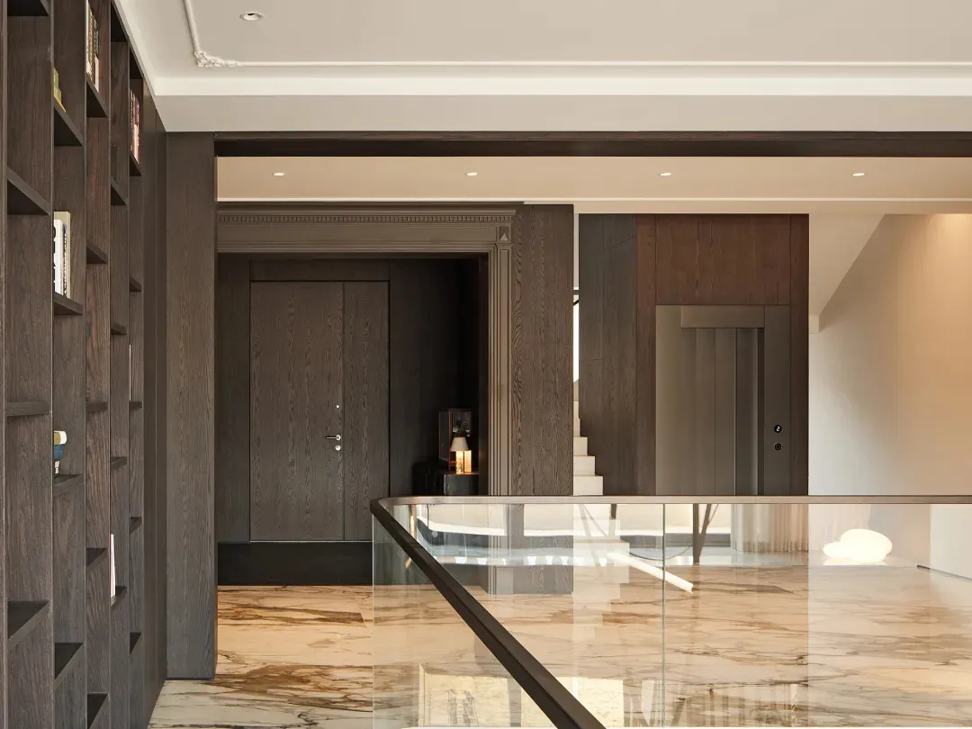 A minimalist residential interior showcases marble flooring and wooden elements.