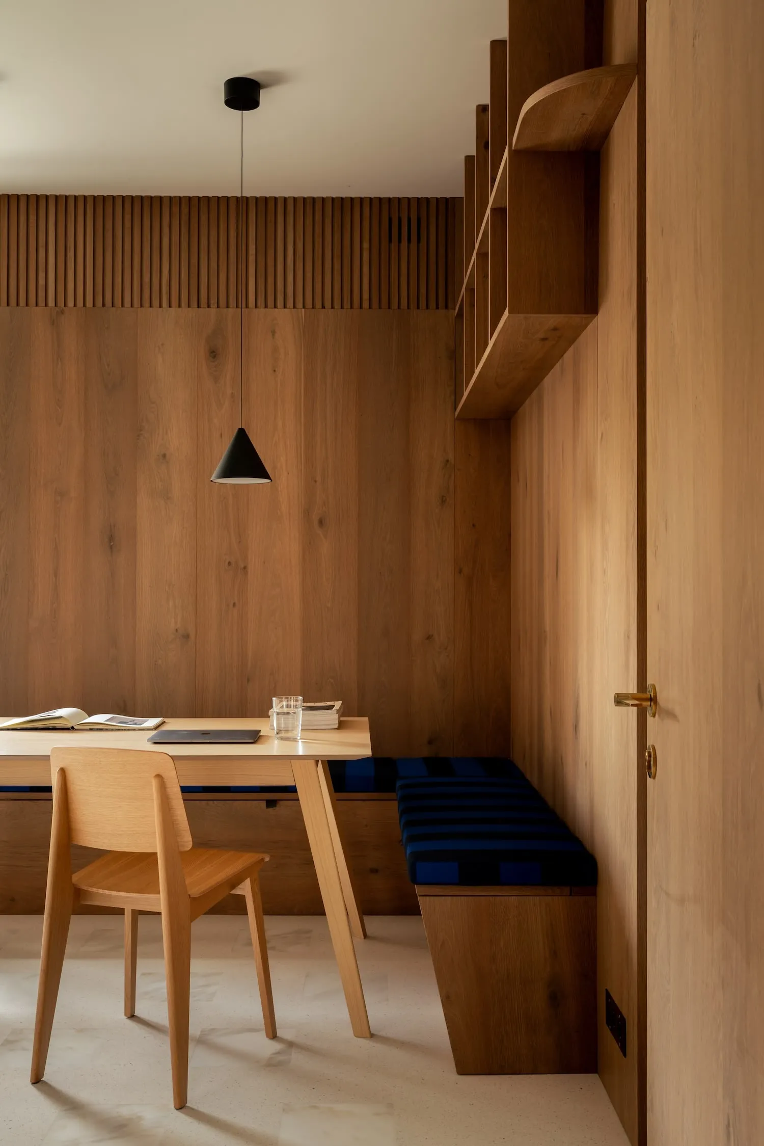 A modern home office with a wooden desk and chair.