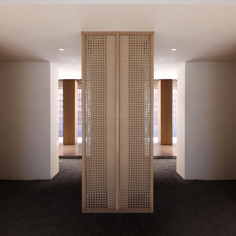 Modern interior design featuring a woven panel wall with a minimalist aesthetic