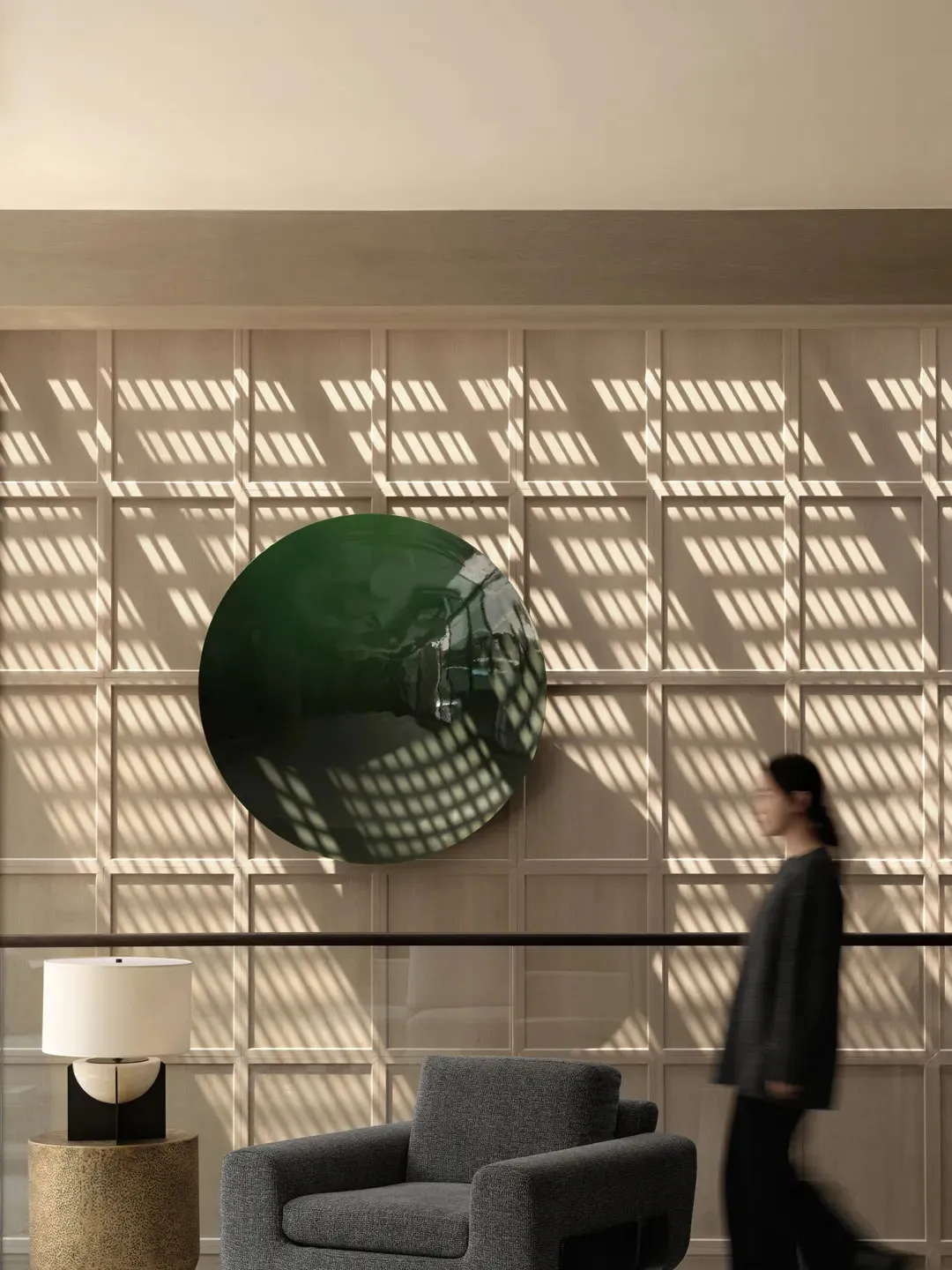 A modern lobby featuring a glass circle with shadow patterns