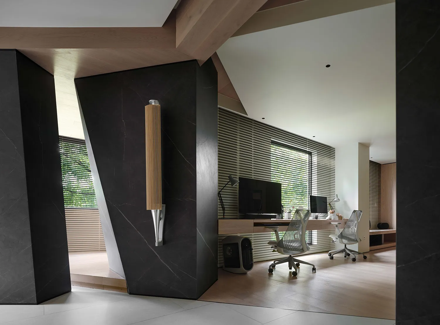 A modern home office featuring dark wooden panels and minimalist design.