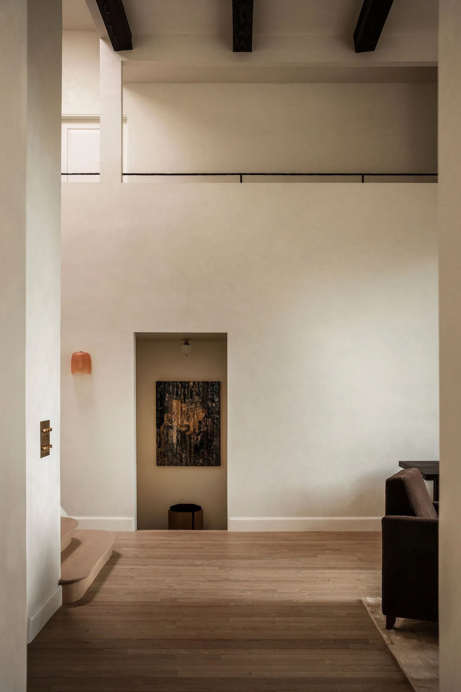 A minimalist interior design featuring wooden flooring and neutral tones.