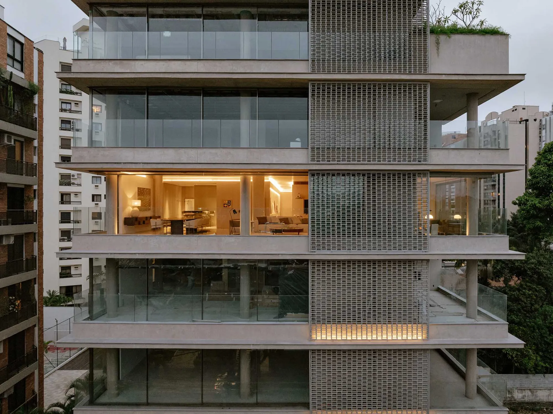 A modern residential apartment building with concrete and glass exterior.