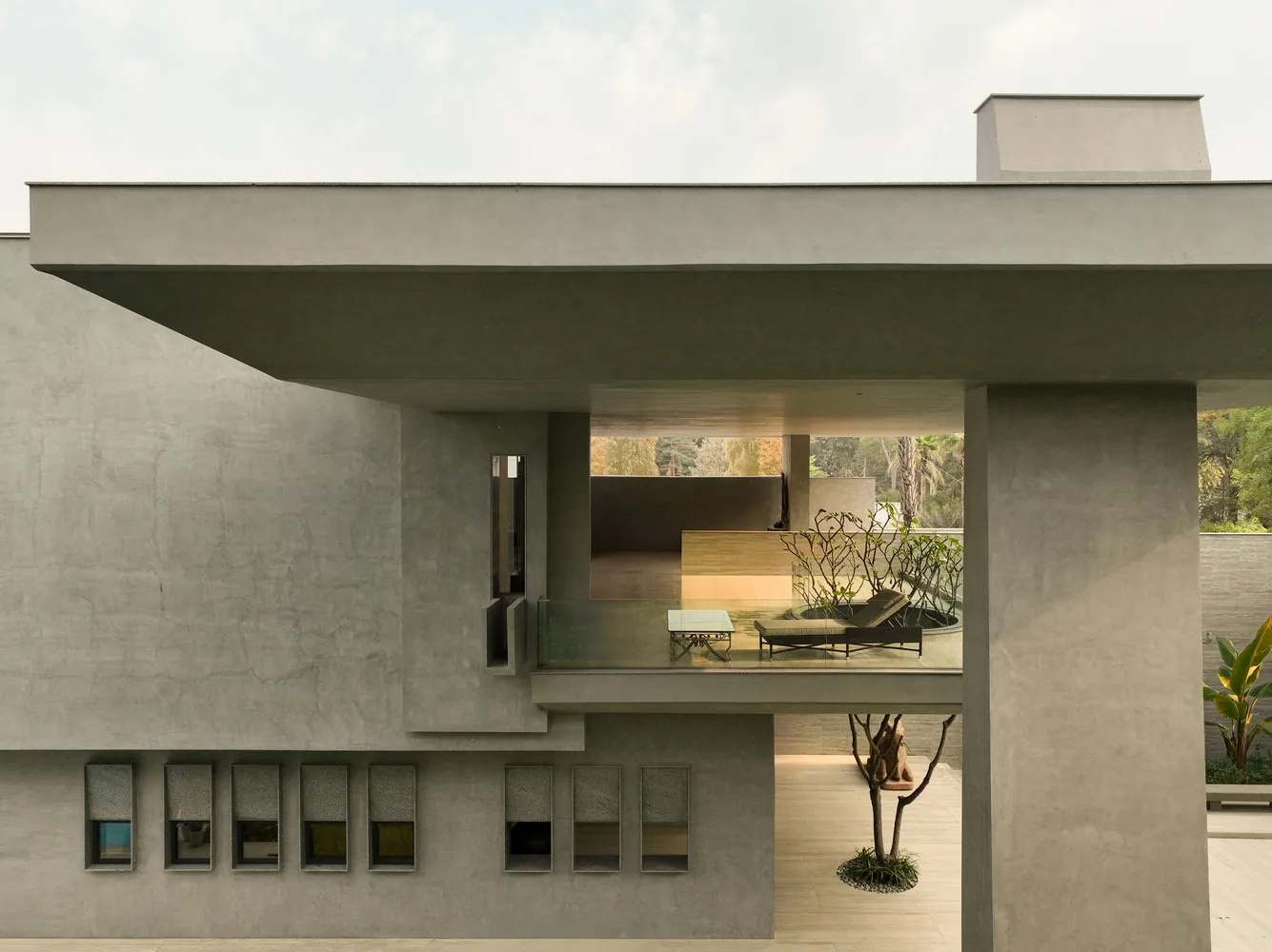 Modern, minimalist architectural design featuring concrete materials and geometric shapes.